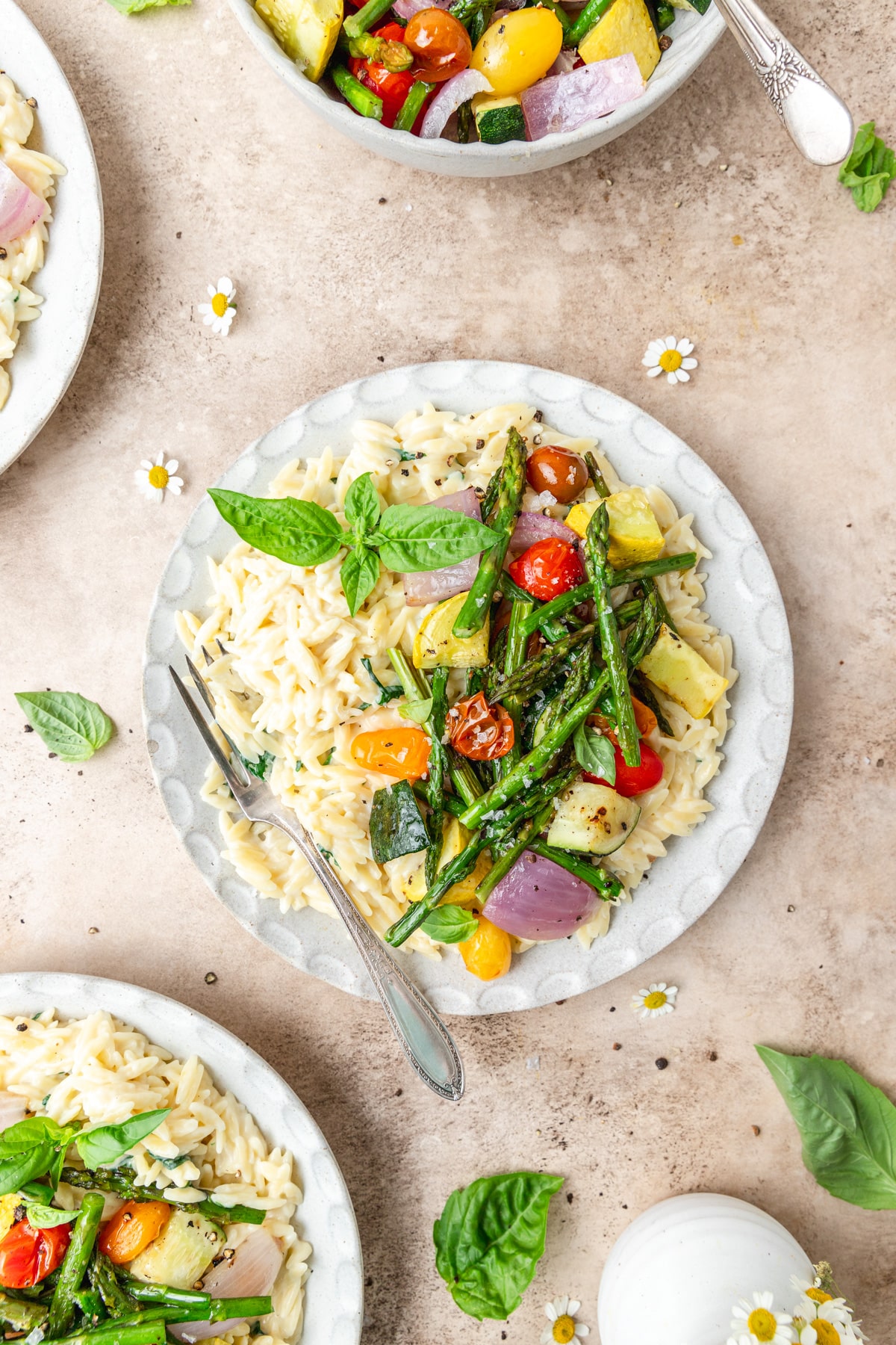 plates of creamy orzo with roasted summer vegetables.