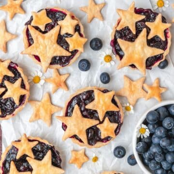 close up shot of mini blueberry pies with star pie crust cutouts.