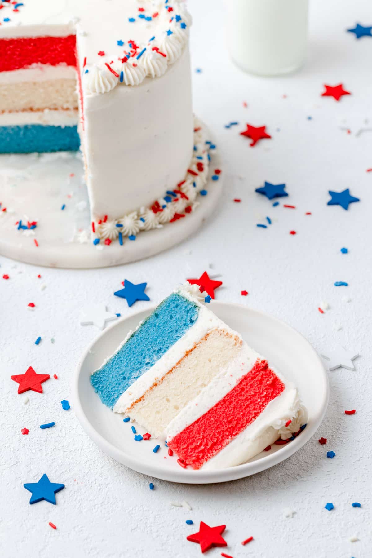 slice of red white and blue layer cake on plate.