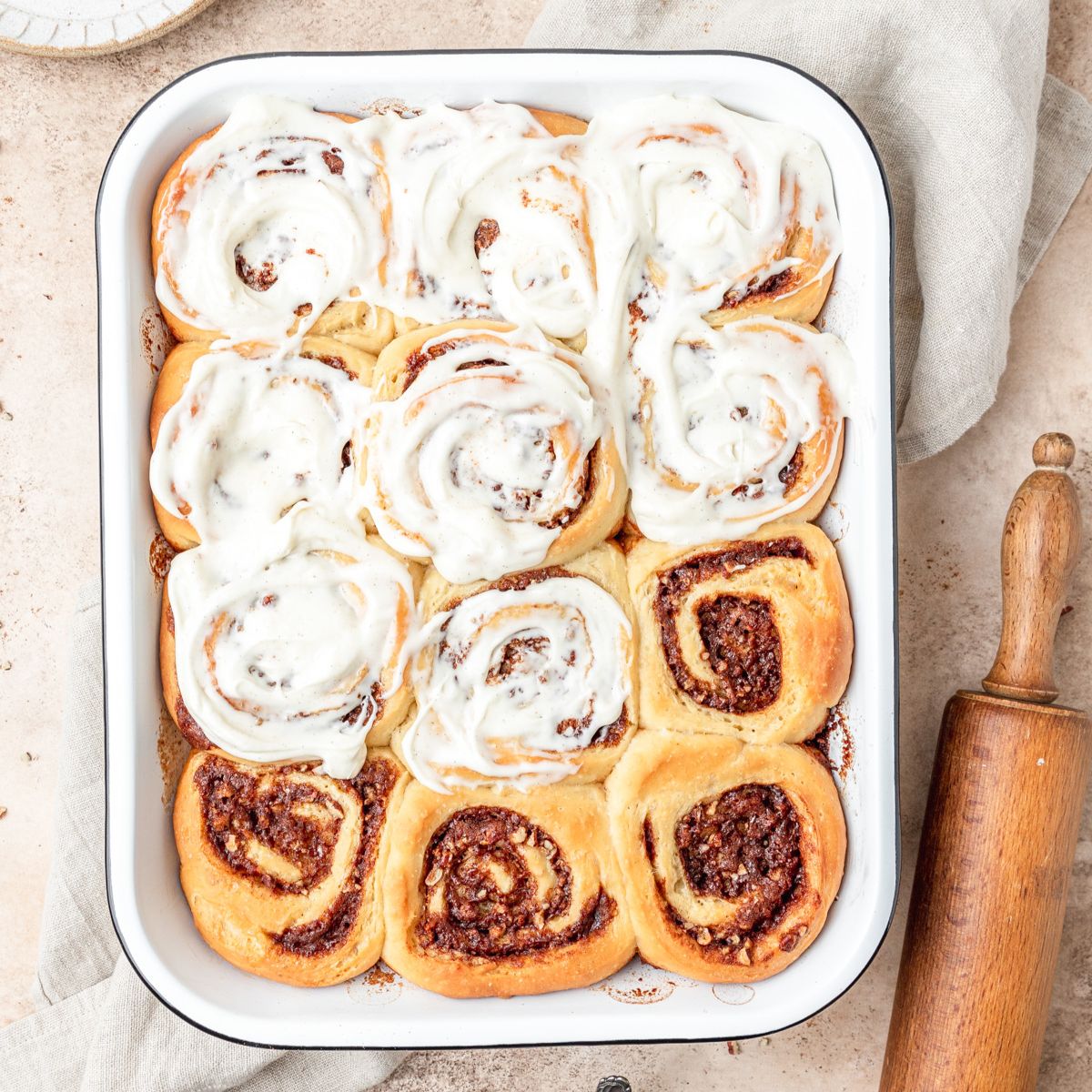 close up shot of sourdough cinnamon rolls with cream cheese glaze.