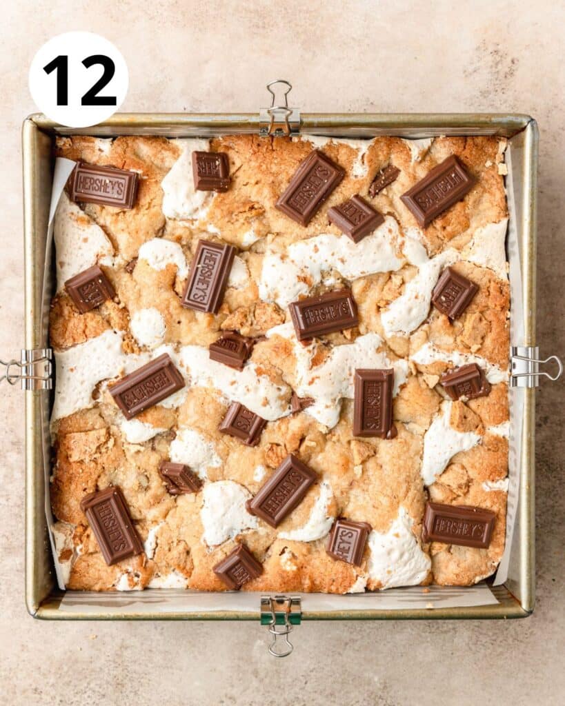 adding hershey's squares to tops of baked s'mores bars.