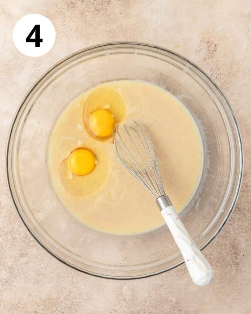 adding eggs to cornbread batter.