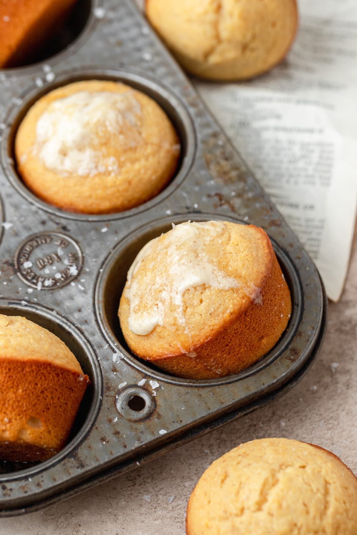 brown butter cornbread muffins topped with honey butter.