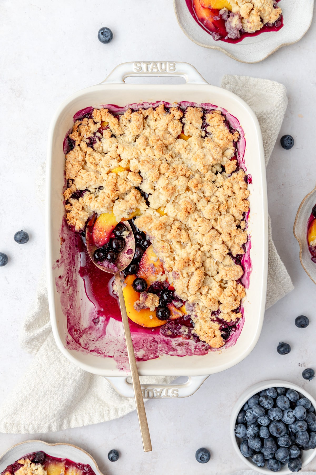 peach blueberry cobbler with crumbly biscuit topping.