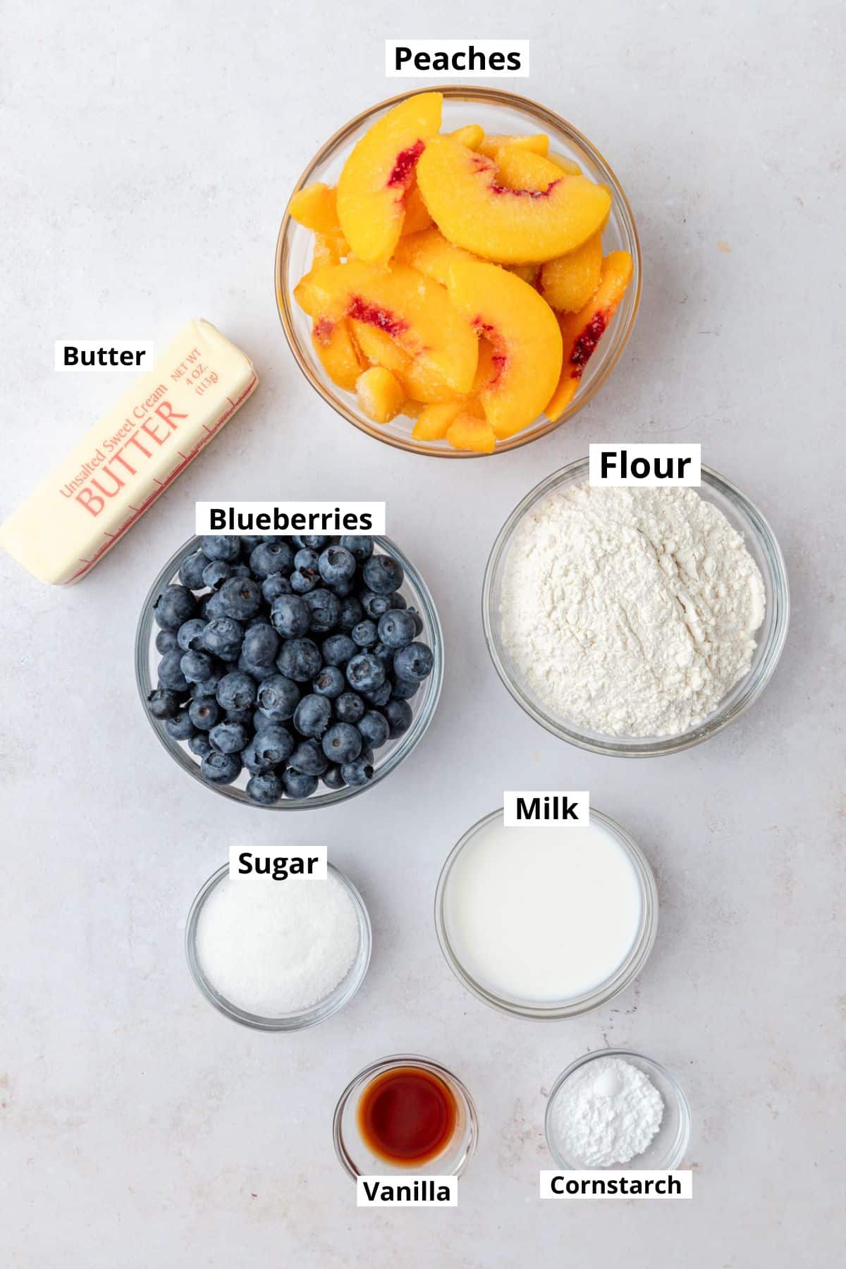 labeled ingredients for peach blueberry cobbler.
