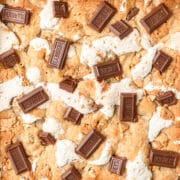 close up shot of s'mores bars topped with mini Hershey's bars.