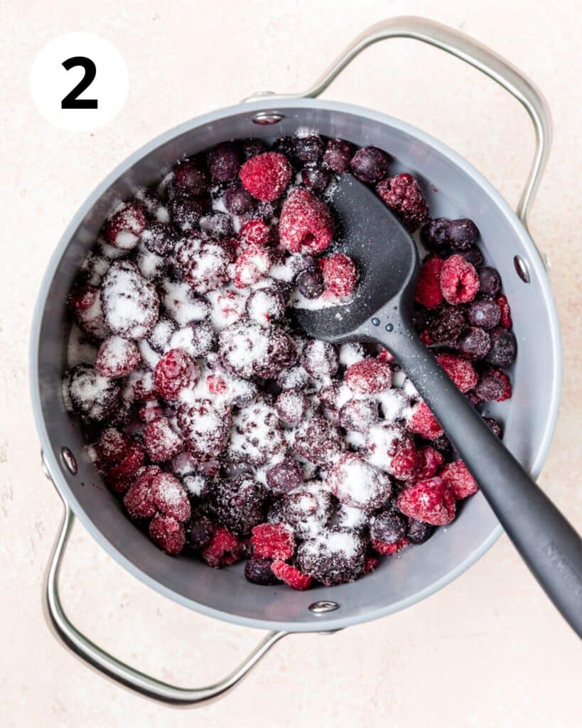 sprinkling berries with sugar.