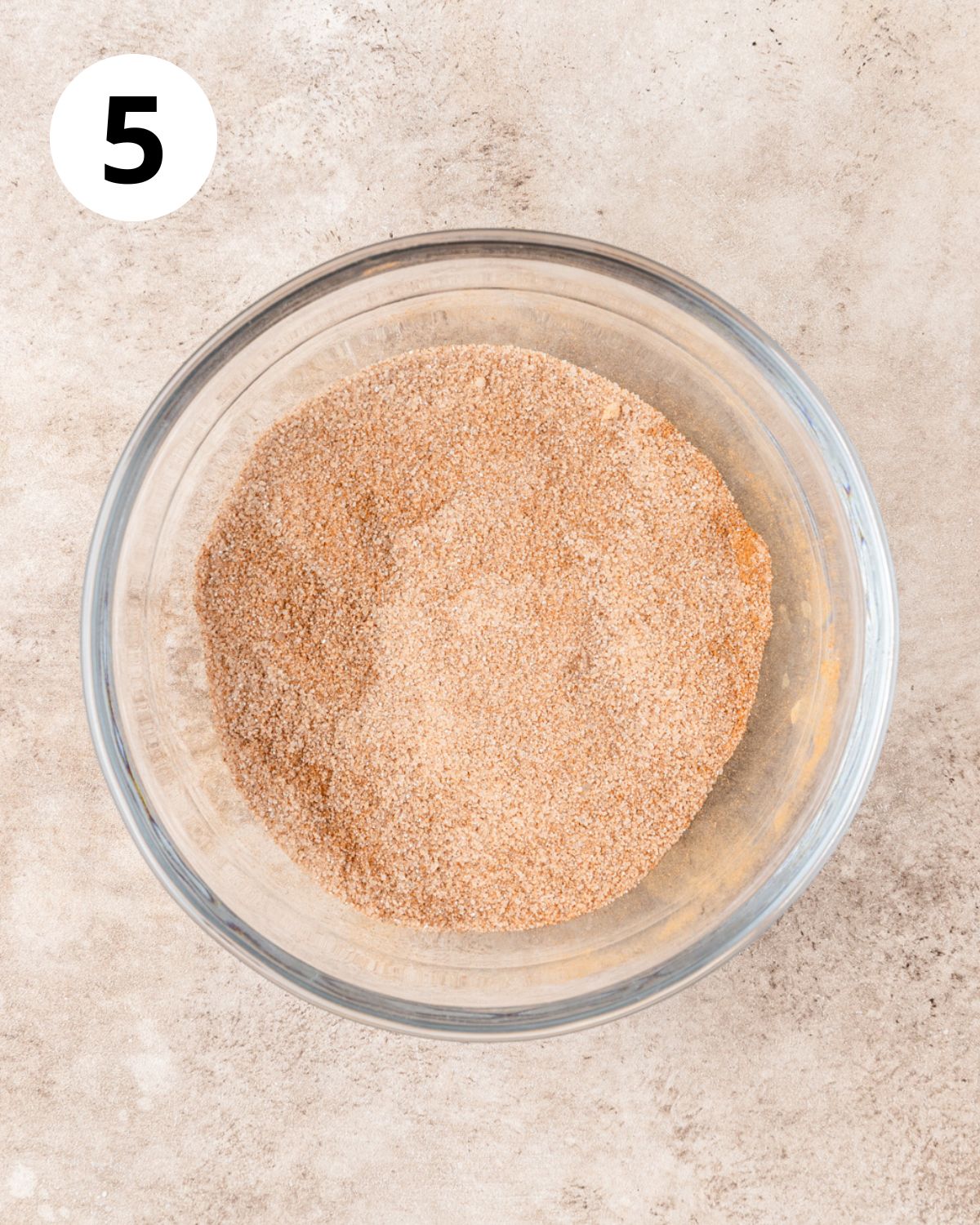 mixing together cinnamon sugar in bowl.