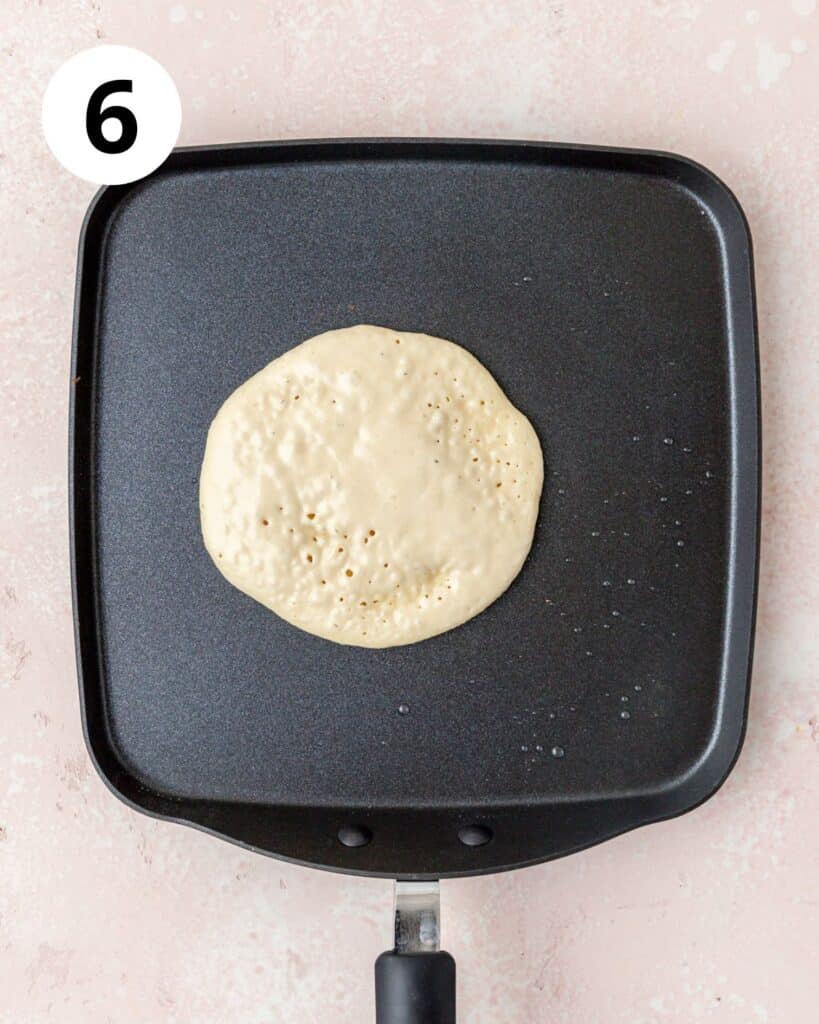 cooking ricotta pancakes on griddle pan.