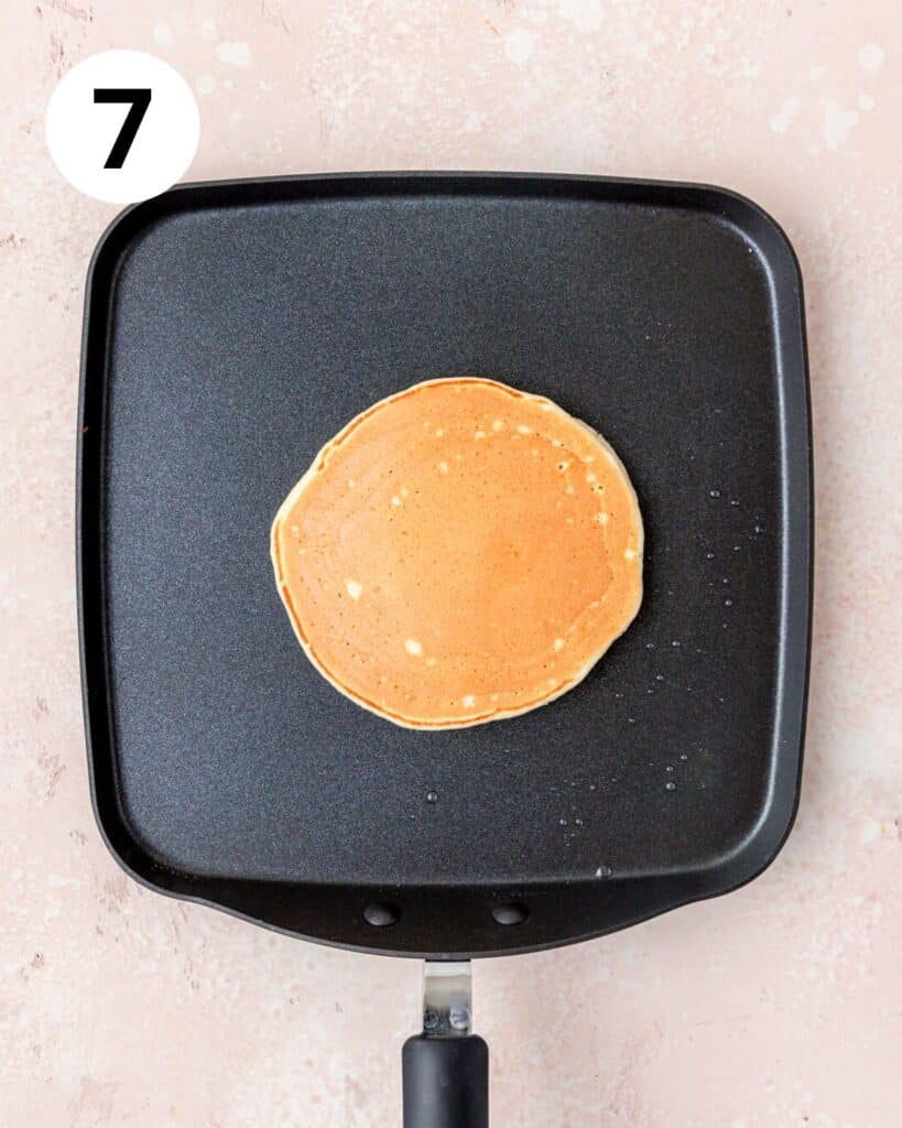 golden brown ricotta pancake on griddle.
