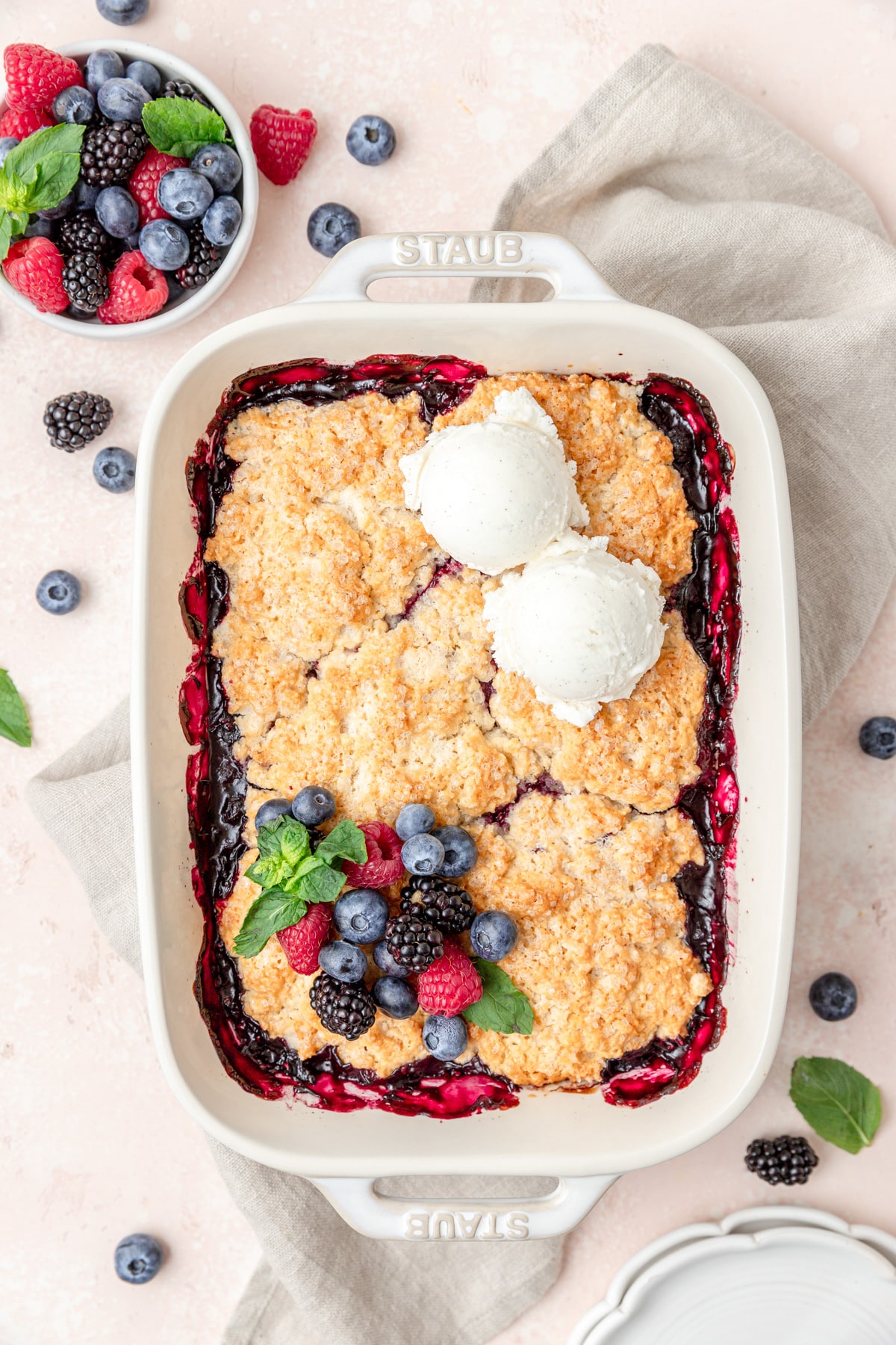 mixed berry cobbler topped with ice cream.