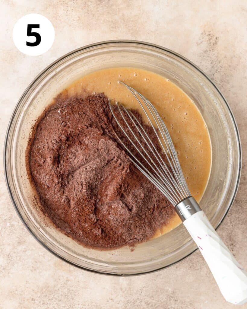 adding dry ingredients to brownie batter.