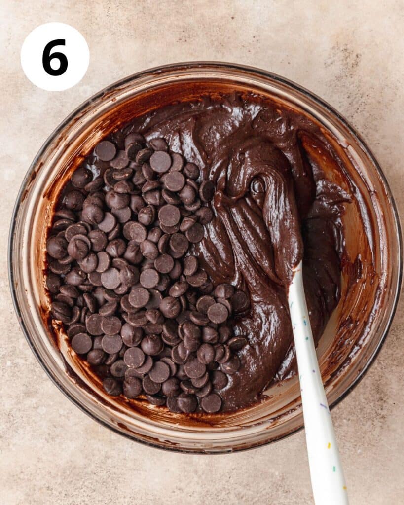 adding chocolate chips to brownie batter.