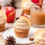 brown butter apple cider cupcakes topped with apple slices.