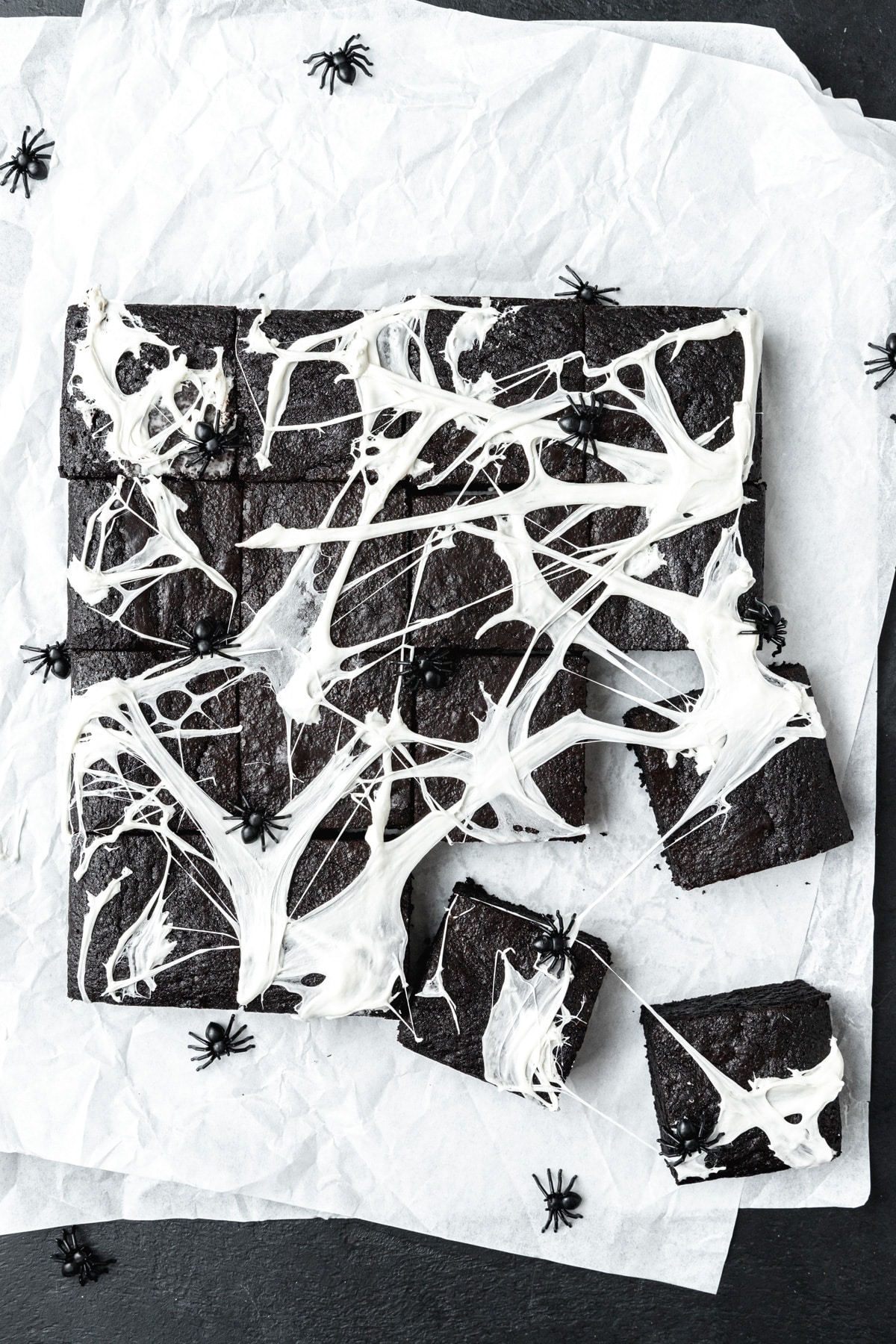 black cocoa brownies with marshmallow spider webs on top.