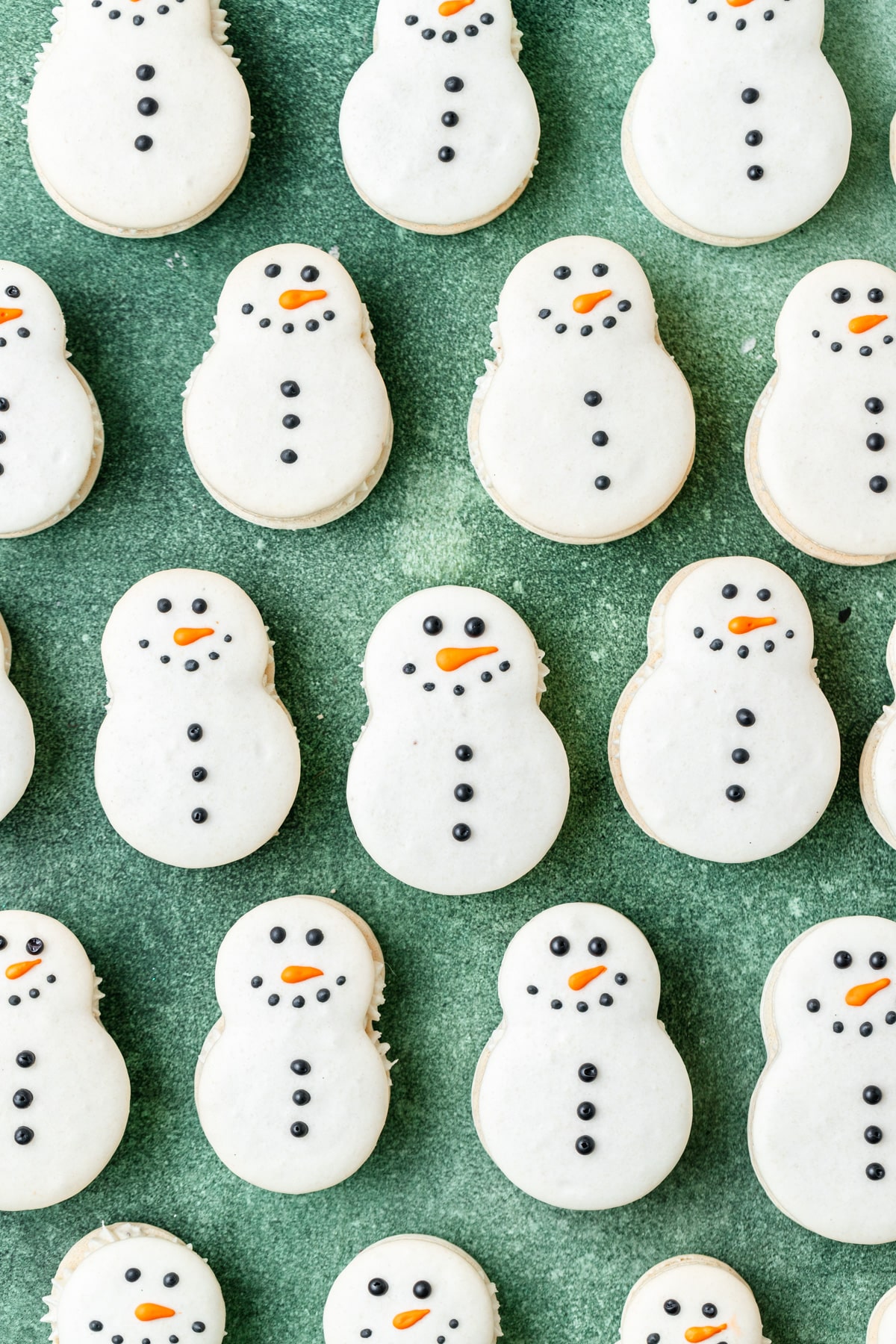 decorated snowman macarons with royal icing.