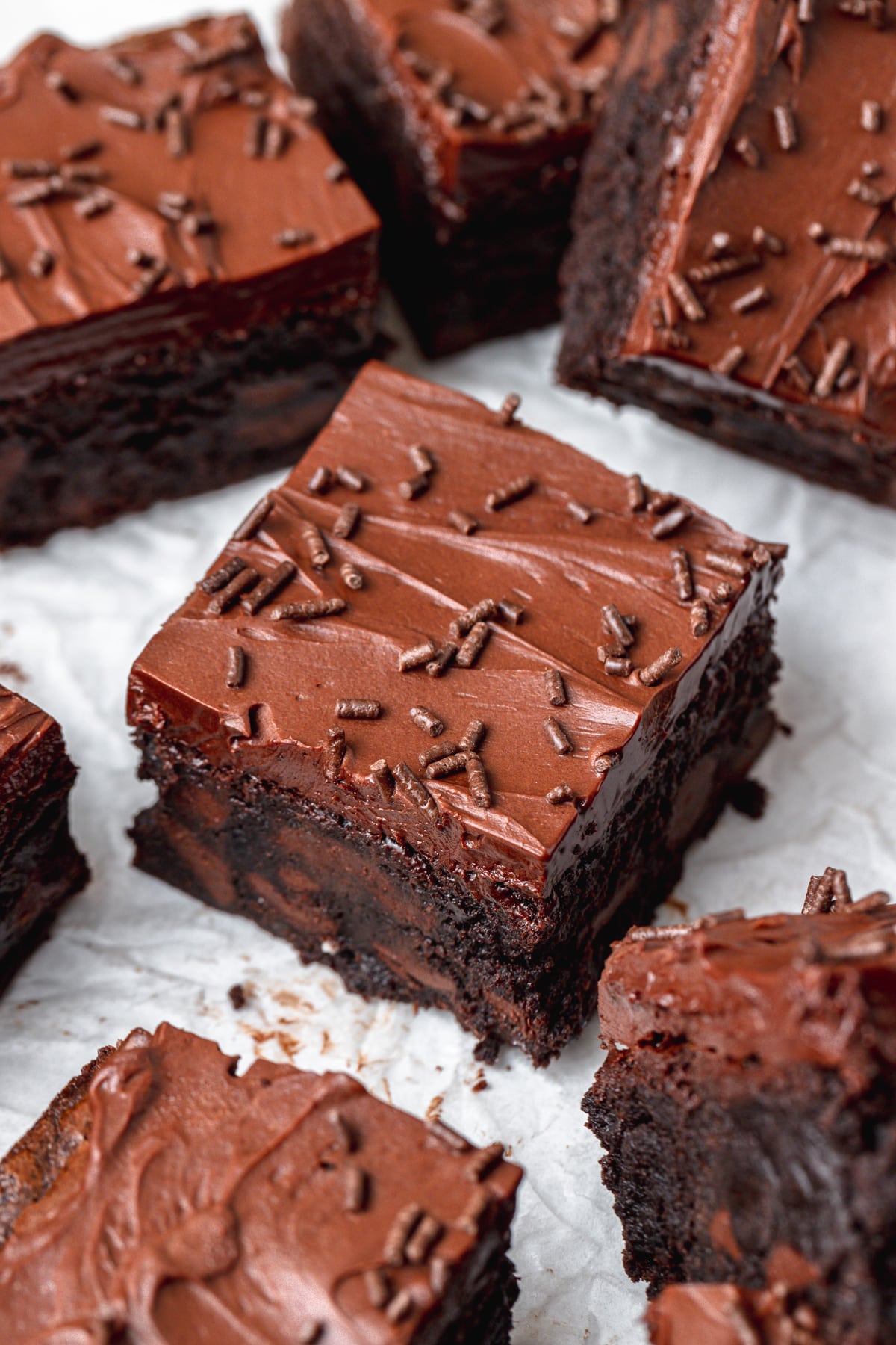 frosted triple chocolate brownies with chocolate sprinkles.