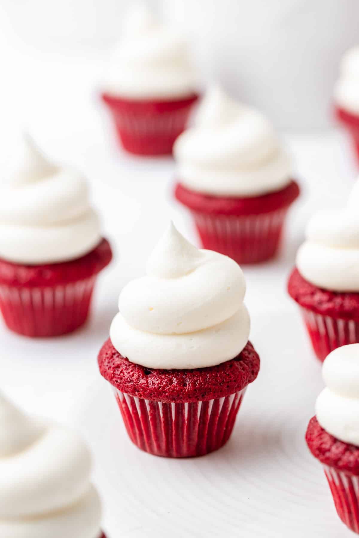 mini red velvet cupcakes topped with cream cheese frosting.