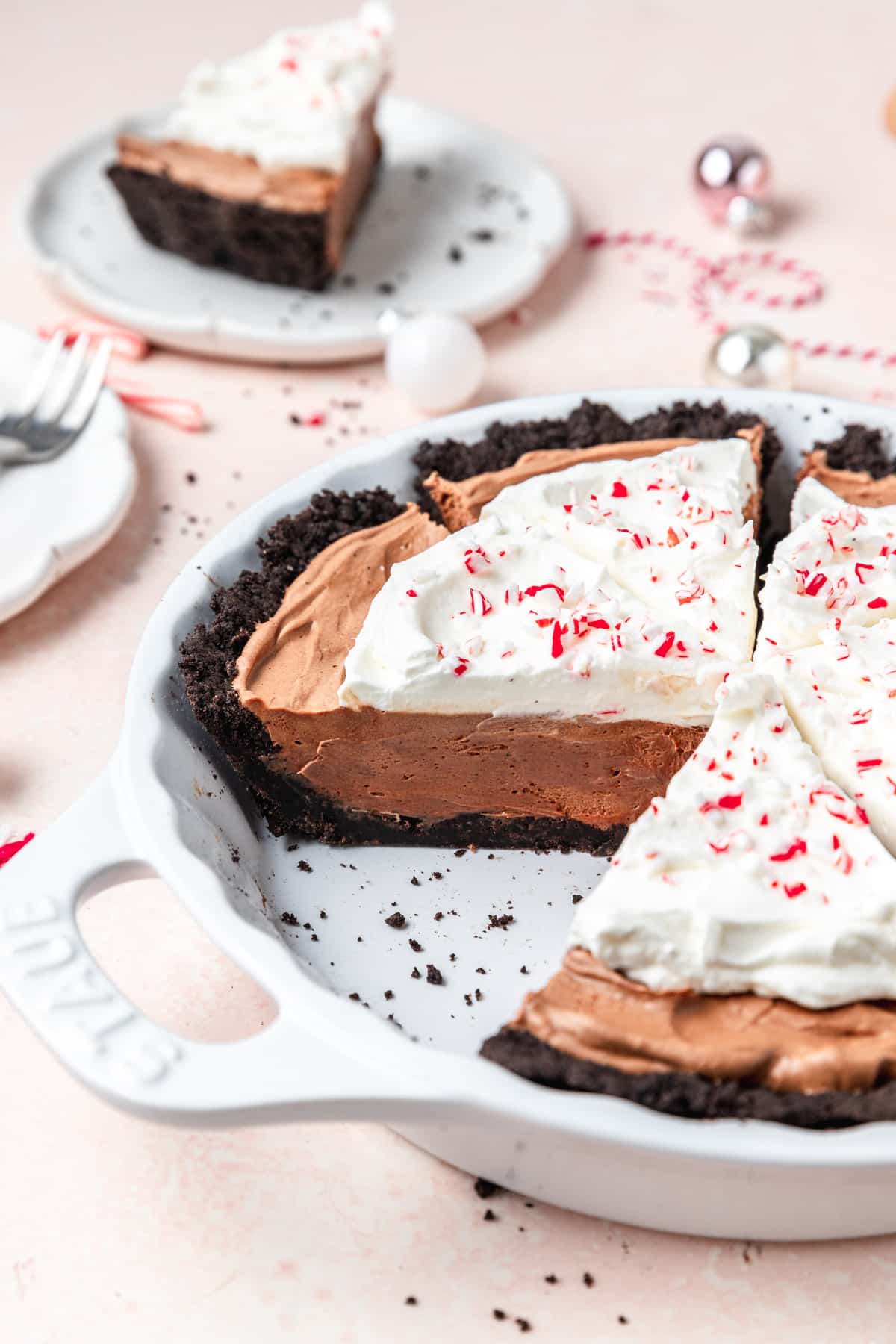 slices cut out of chocolate peppermint pie with whipped cream.