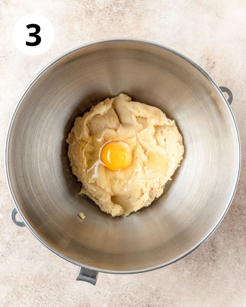 adding eggs to churro dough.