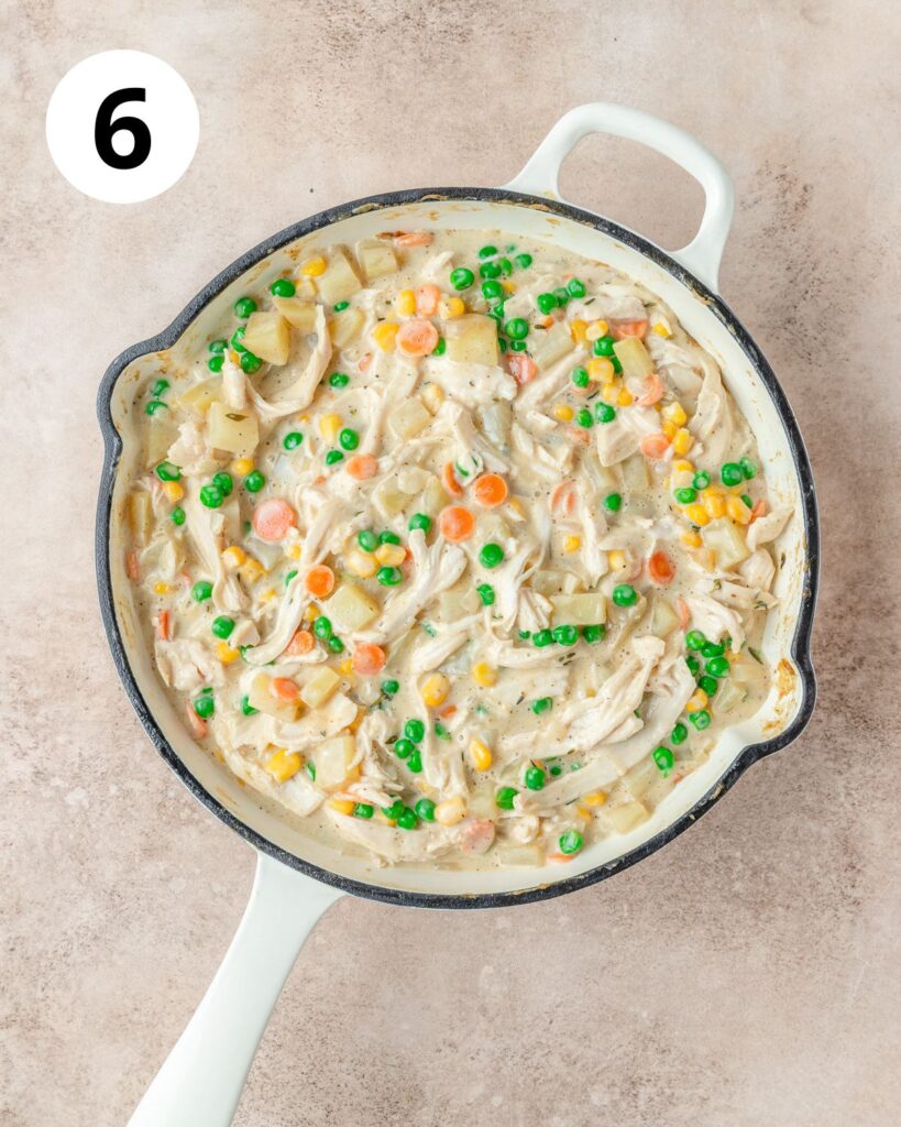 creamy chicken pot pie filling in skillet.