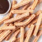 close up of homemade churros with chocolate sauce.