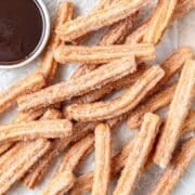 close up shot of homemade churros with chocolate sauce.