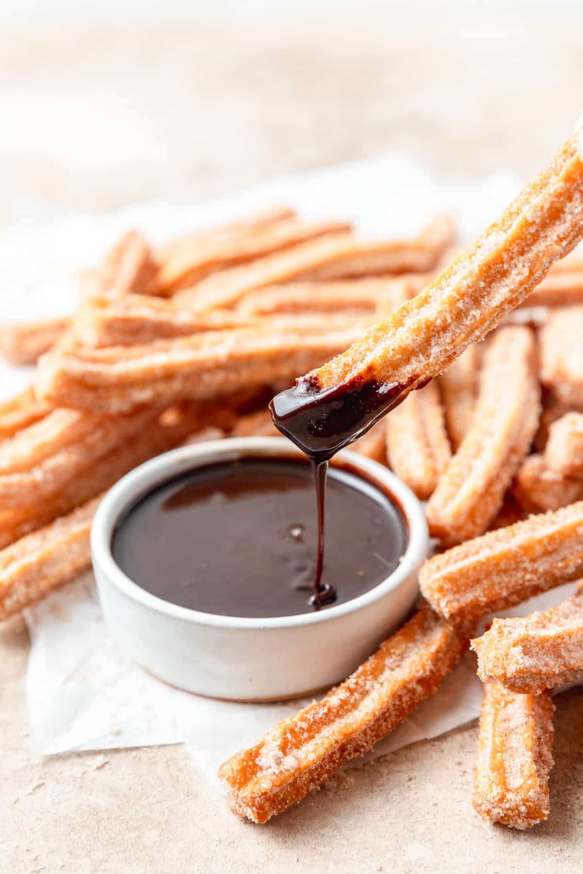homemade churros dipped in chocolate sauce.