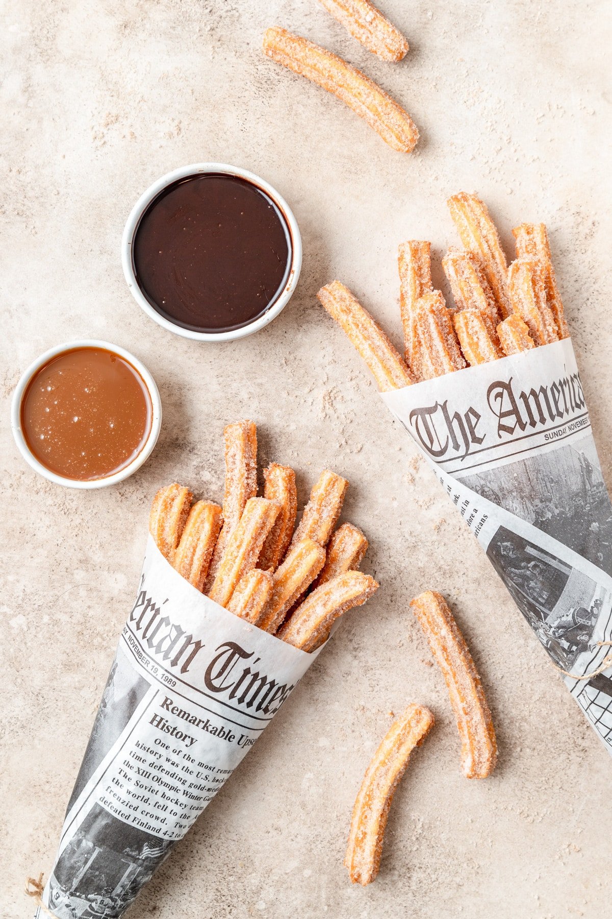 homemade churros wrapped in newspaper.