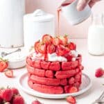 stack of strawberry waffles with homemade strawberry syrup.