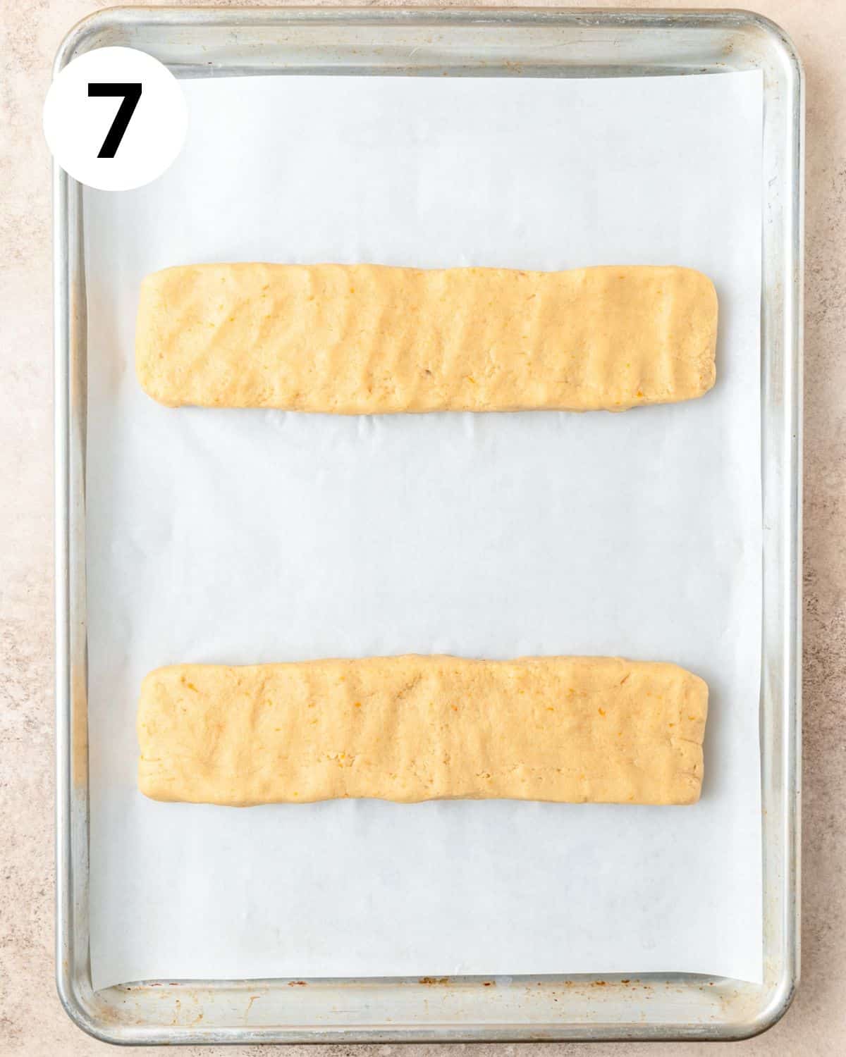 orange biscotti logs formed before baking. 