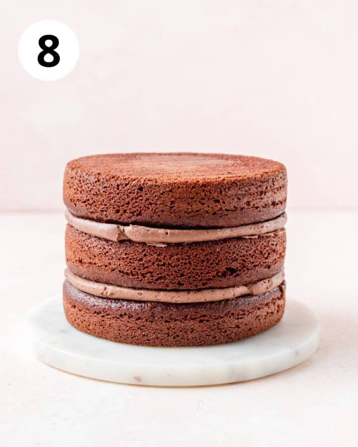 chocolate cake stacked before frosting.