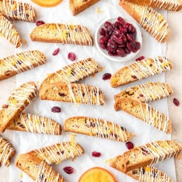 cranberry orange biscotti drizzled with white chocolate.