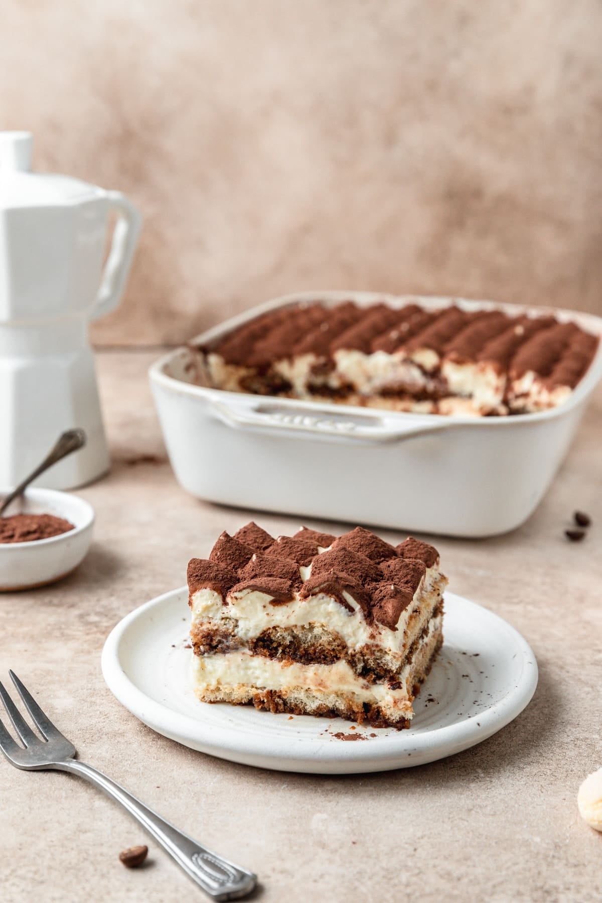 slice of classic tiramisu on plate.