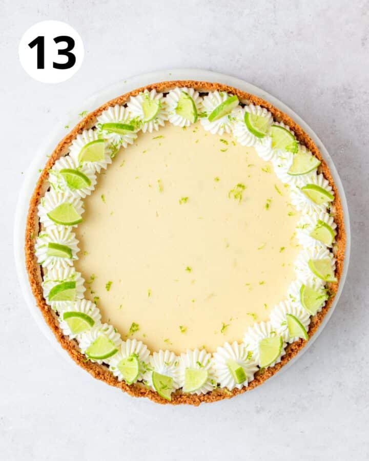 topping key lime cheesecake with key lime slices and zest.