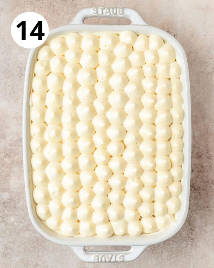 piping mascarpone on top of tiramisu.