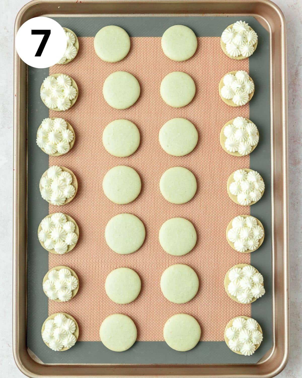 piping filling into baked macarons.