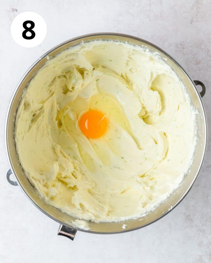 adding eggs to cheesecake filling.