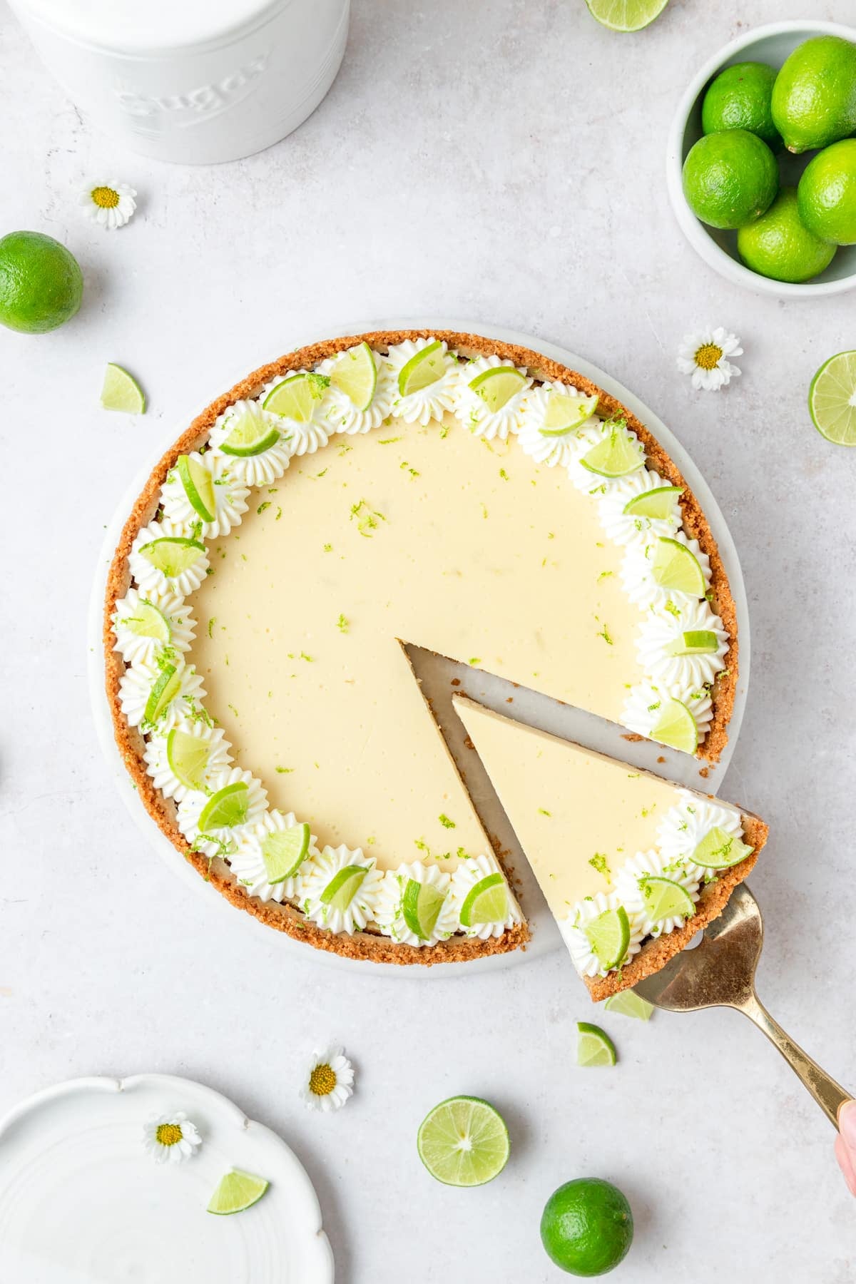 key lime cheesecake with slice taken out.