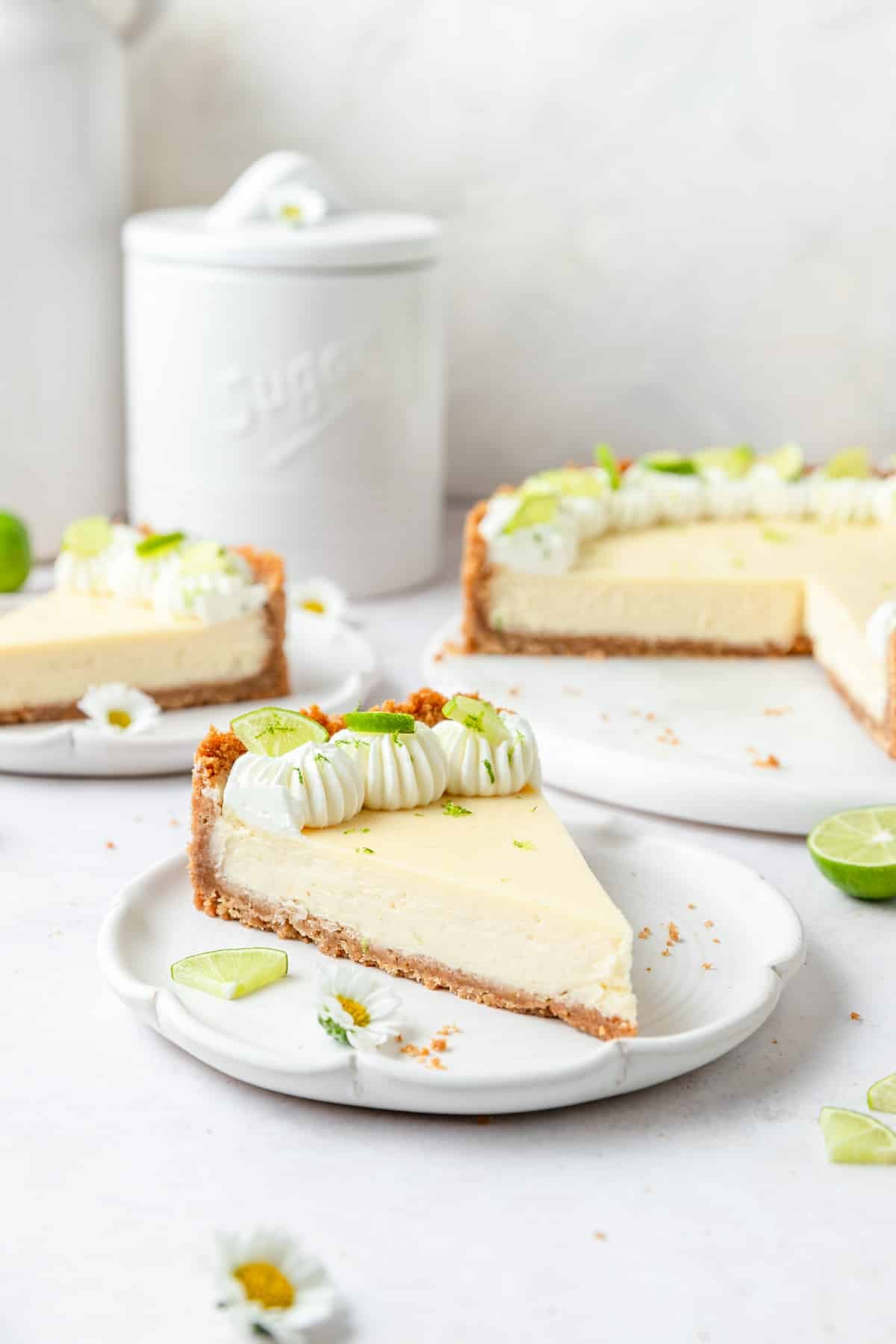 slice of key lime cheesecake topped with whipped cream.