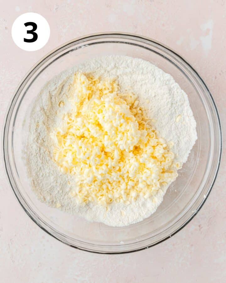adding grated butter to dry ingredients.