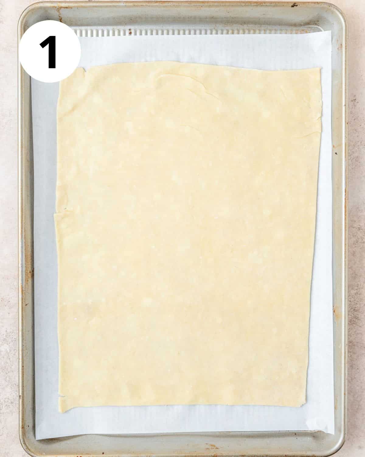 rolling pie dough out into large rectangle.