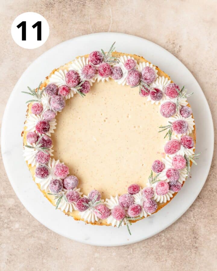 topping cheesecake with sugared cranberries and rosemary.