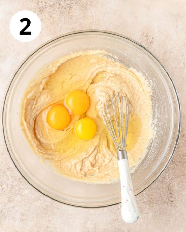 adding eggs to cake batter.