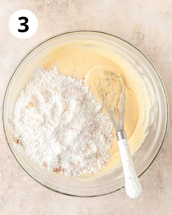 adding dry ingredients to cake batter.