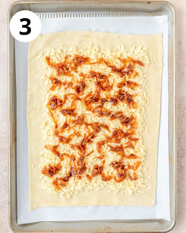 spreading caramelized onions over cheese.