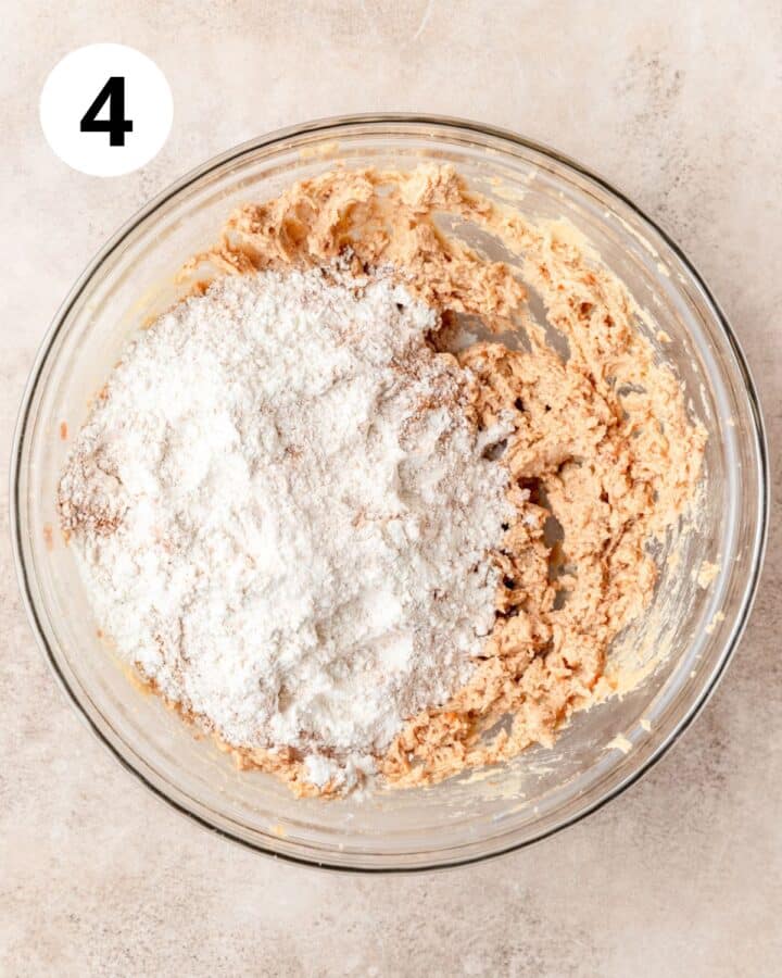 adding dry ingredients to cookie dough.