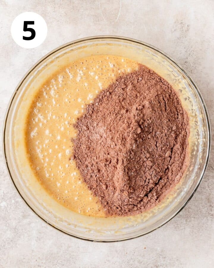 adding dry ingredients to brownie batter.