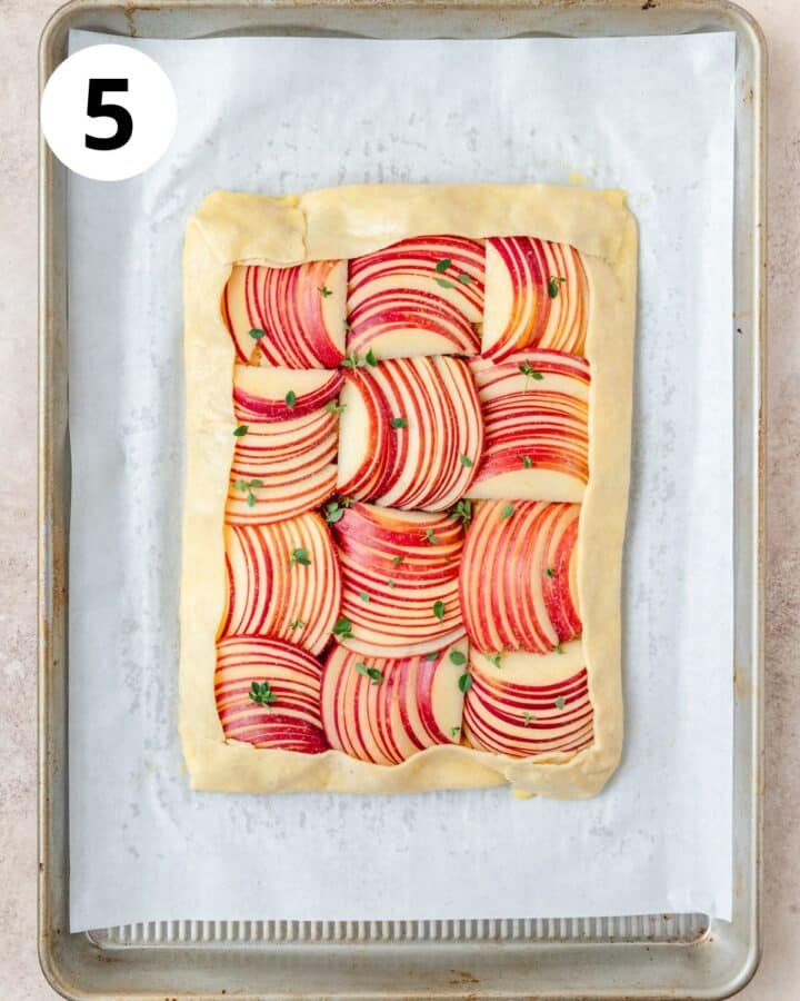 folding edges of pie dough up over apples.