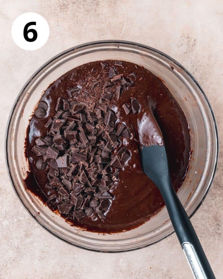 adding chopped chocolate to brownie batter.